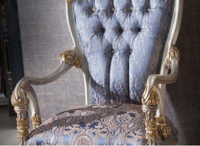 Luxurious armchair in classic style for the living room with golden decorative patterns